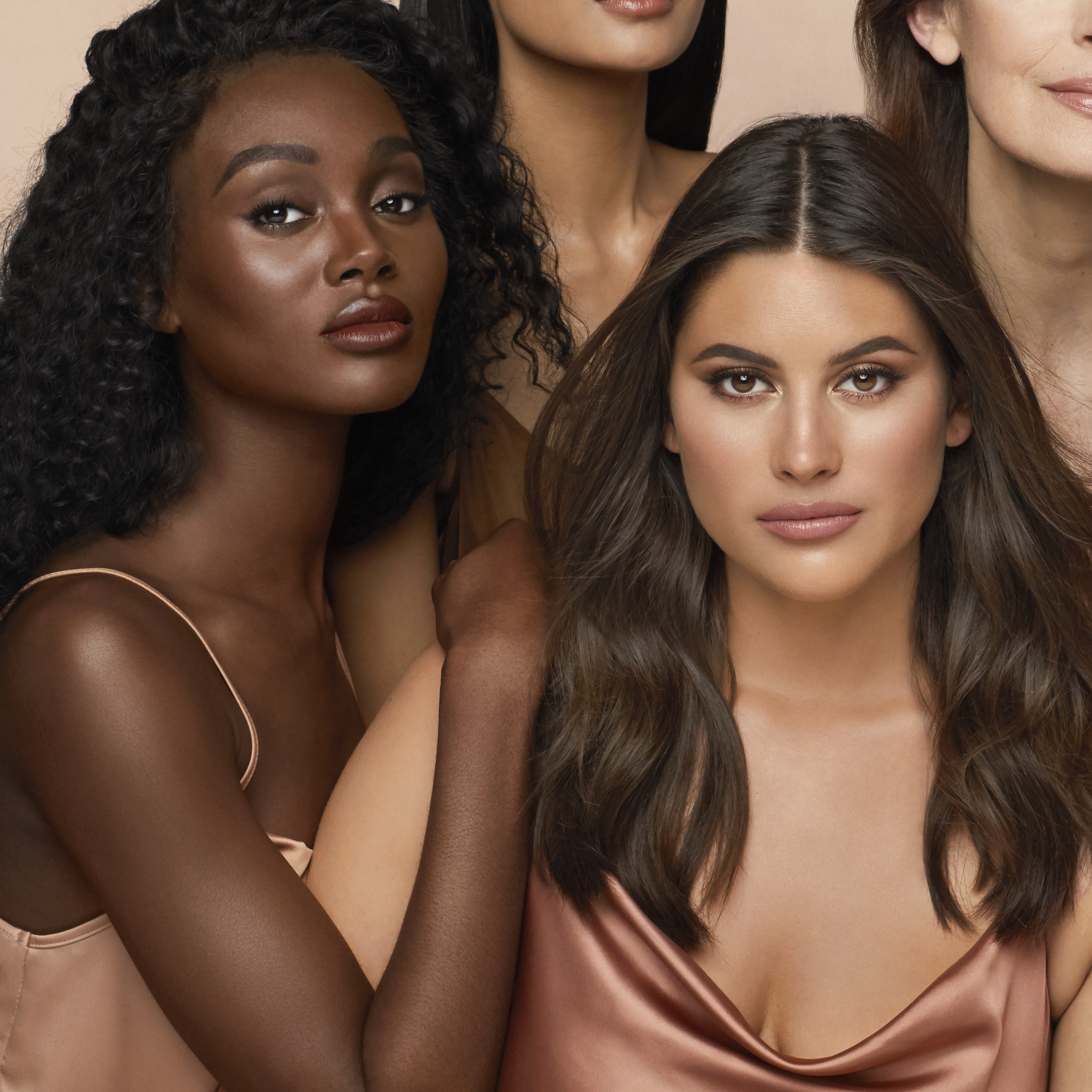 Medium and deep-tone models with flawless smooth skin and wearing nude pink lipstick with subtle, glowy blush, and smokey eye makeup.