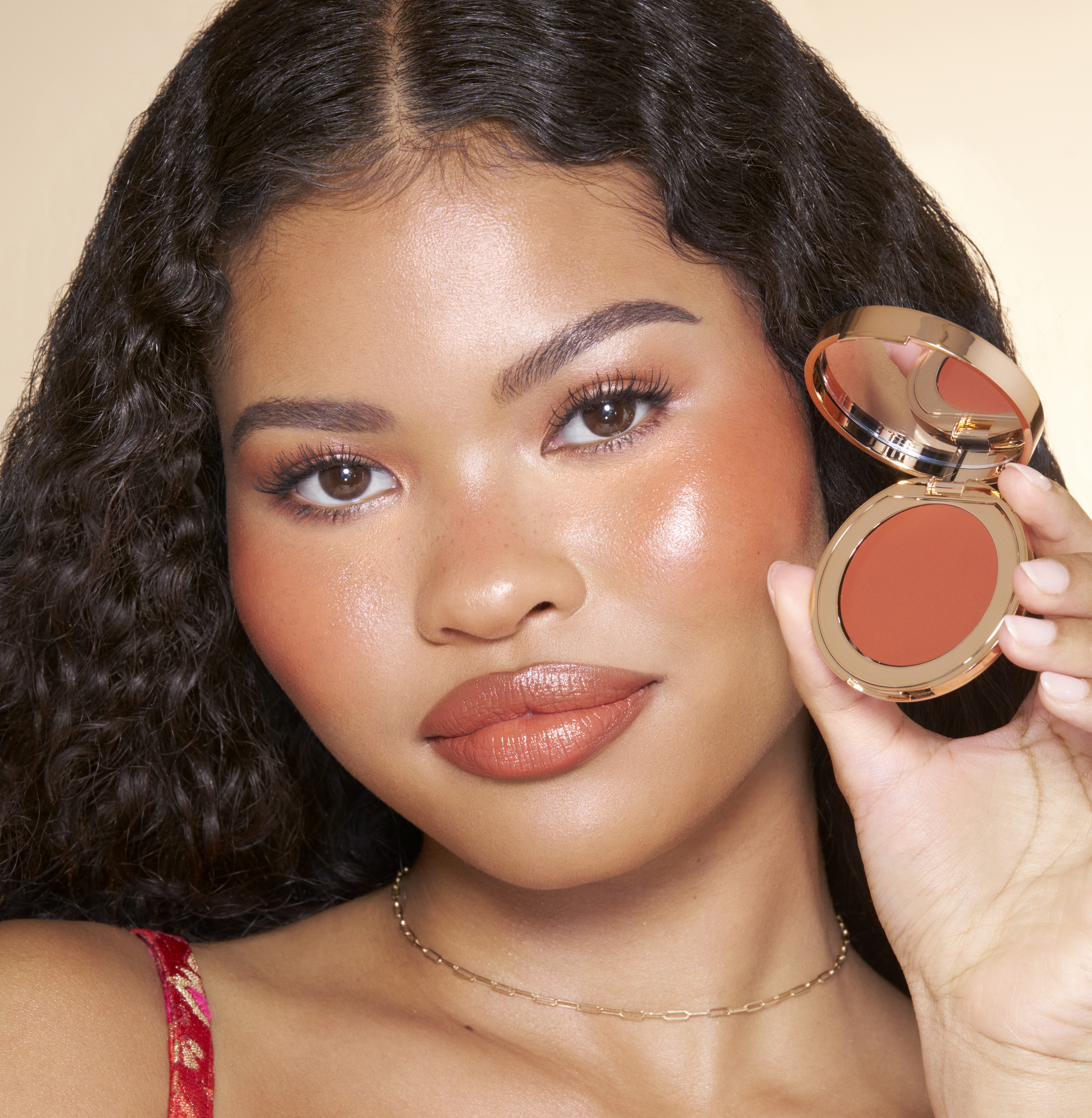 Model wearing a terracotta summer blush look created with Sunset Bronze Glow