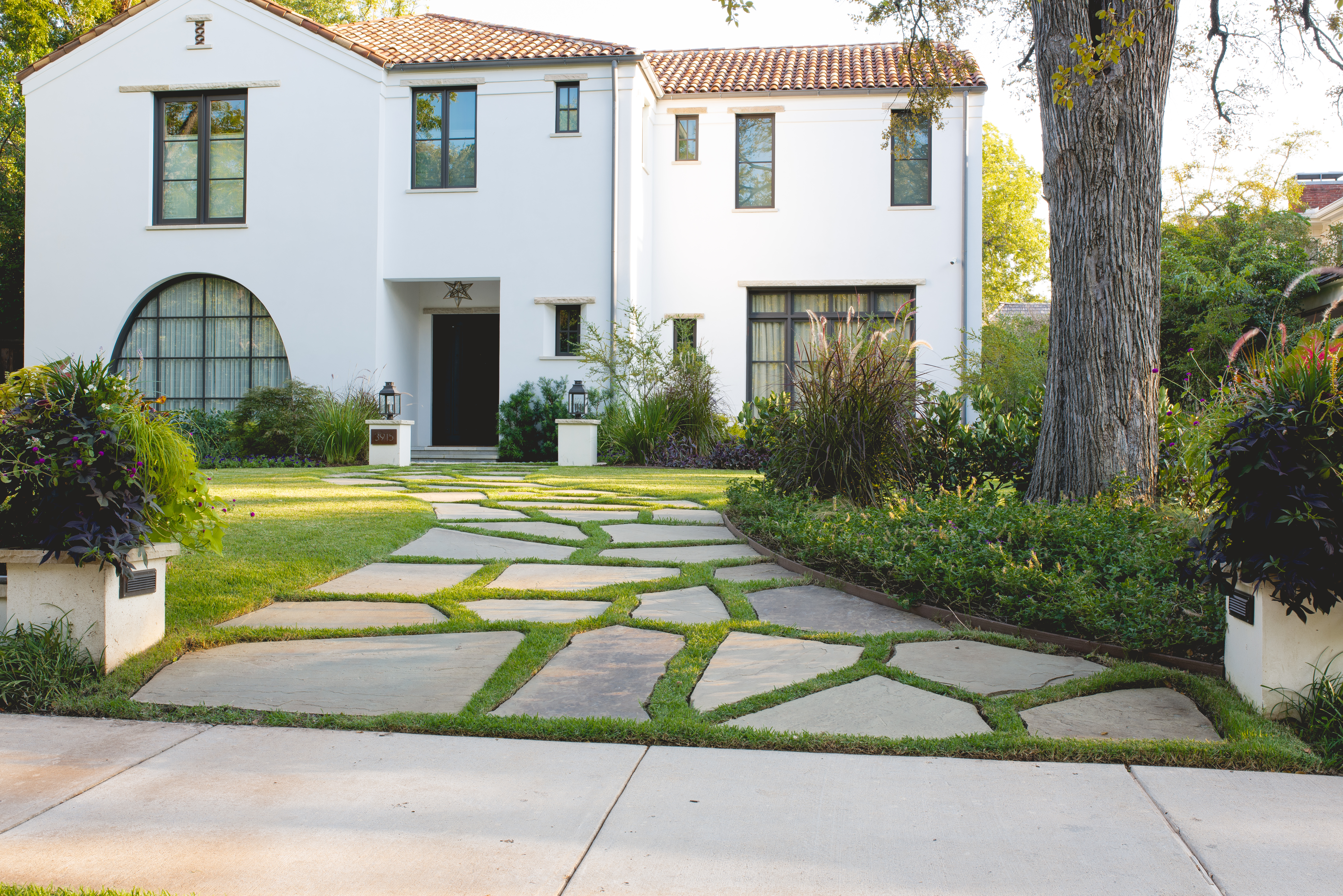 White Mediterranean-style home with stone walkway

