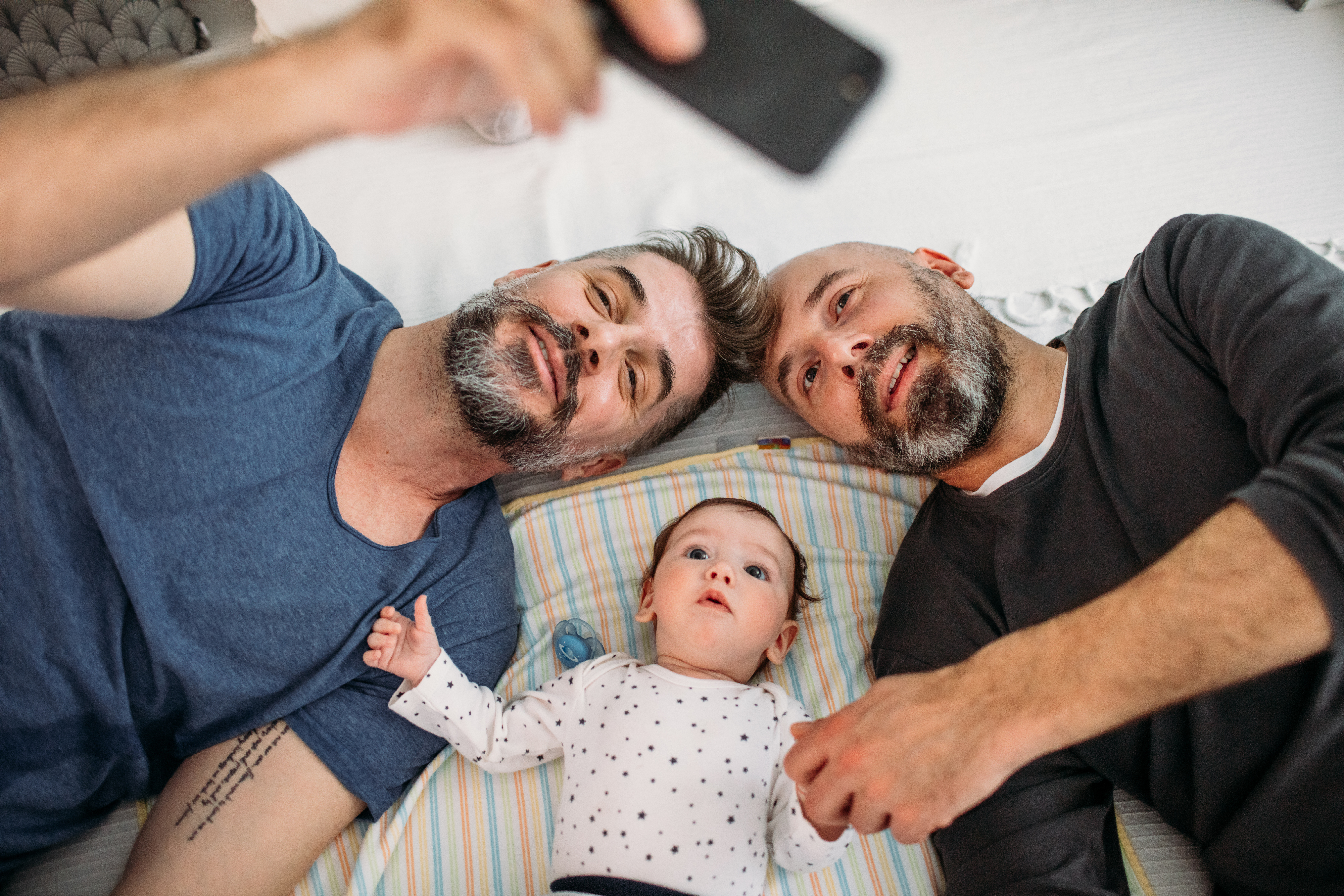 Male Couple taking selfie with baby