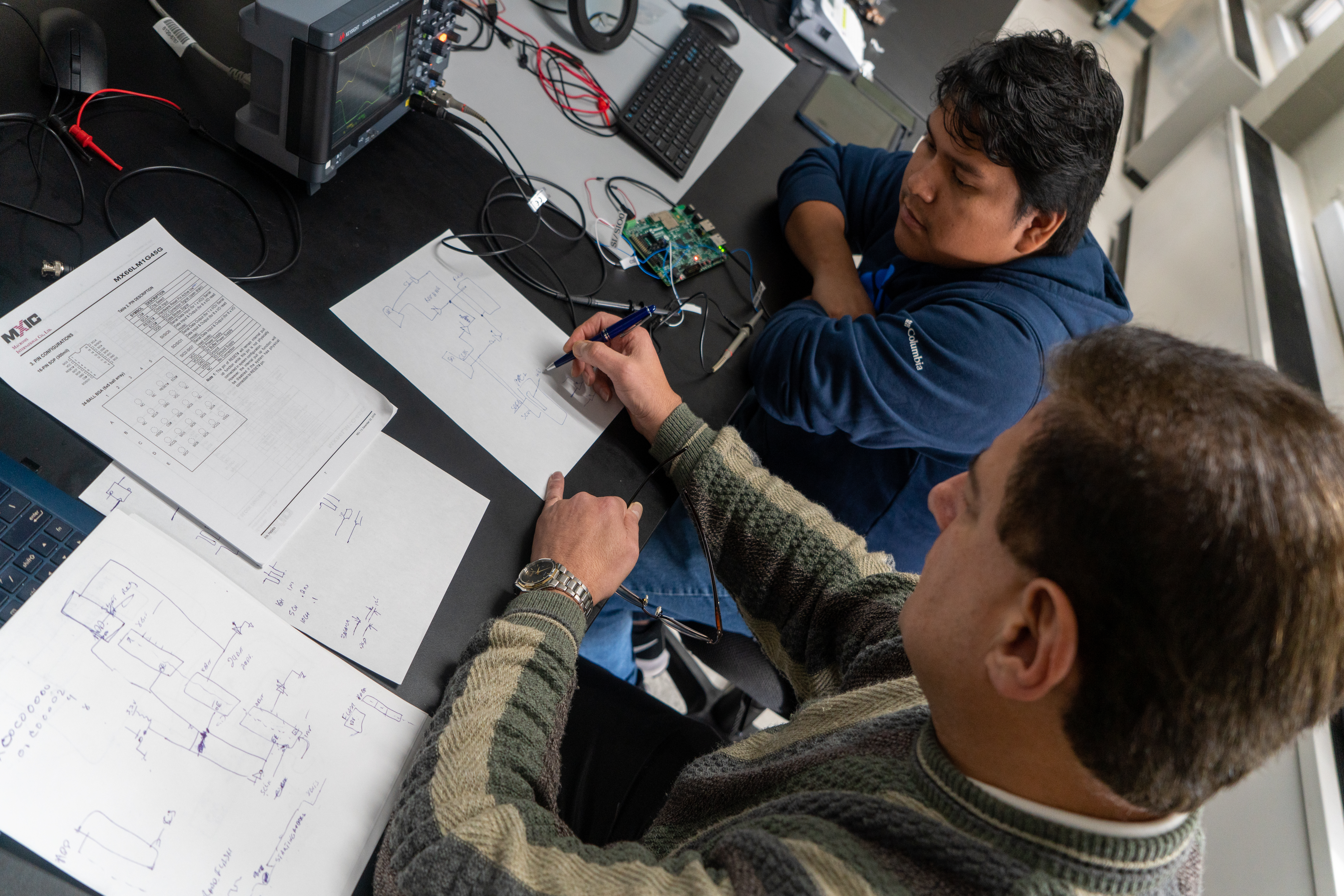 Professor and Student Reviewing Diagrams