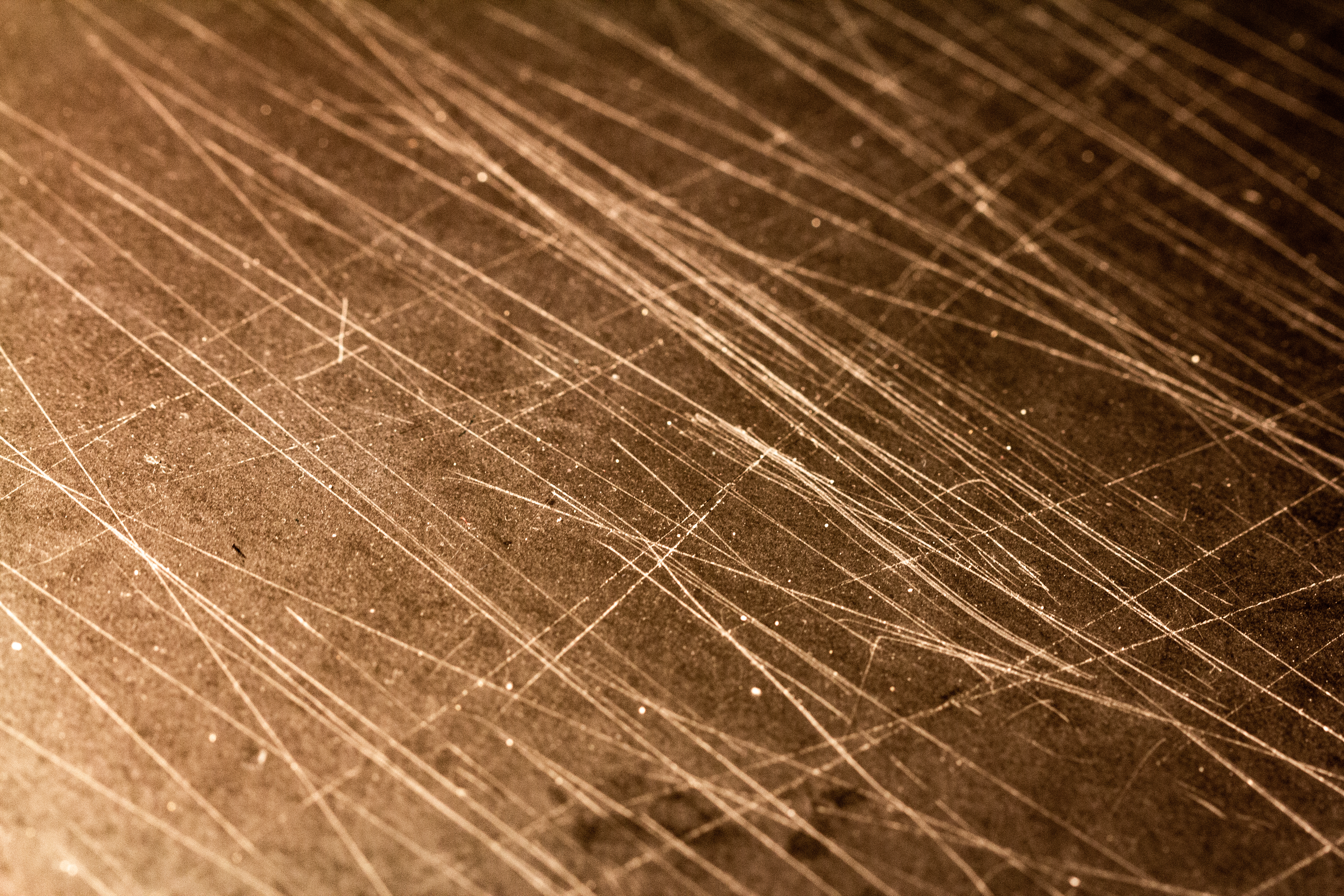 A photograph of some scratches in a dark suface.